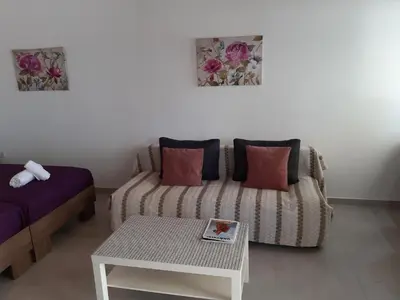 a living room with a couch and a table at ZORBAS Sea View No 5 in Larnaka