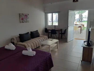 a living room with two beds and a couch at ZORBAS Sea View No 5 in Larnaka