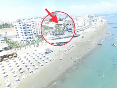 an aerial view of a beach with a red arrow at ZORBAS Sea View No 5 in Larnaka