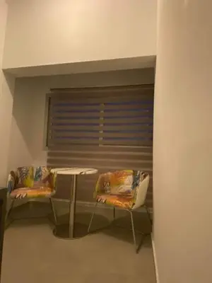 a room with two chairs and a table and a window at ElleNapa Apts & Studios in Ayia Napa
