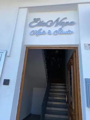 a stairway leading into a building with a sign on it at ElleNapa Apts & Studios in Ayia Napa