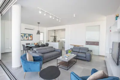 a living room with a couch and chairs and a table at Villa Naya in Protaras