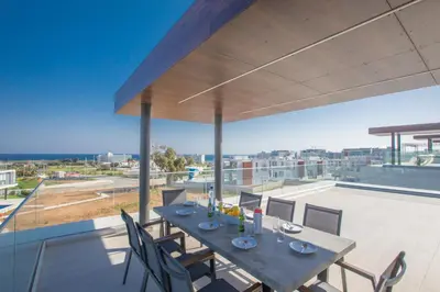 a dining table on the roof of a house at Villa Naya in Protaras
