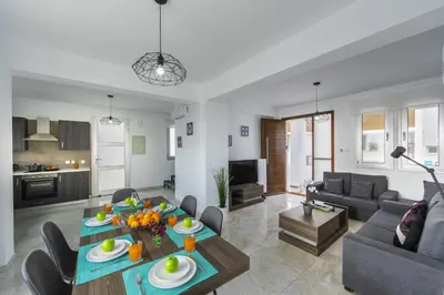 a living room with a couch and a table with fruit on it at Protaras Villa Alasia in Protaras