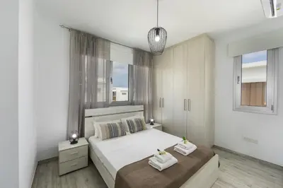 a bedroom with two beds with towels on them at Protaras Villa Alasia in Protaras
