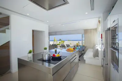 a kitchen and living room with a view of the ocean at Central Protaras Seaview Villa Zinnia in Protaras