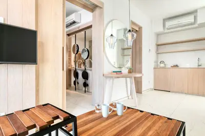 a living room with a flat screen tv on a wall at King Jason Protaras - Designed for Adults by Louis Hotels in Protaras
