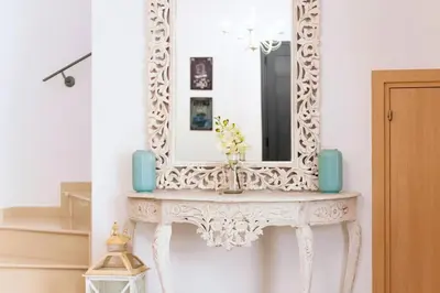 a mirror on top of a console table in a room at Villa Katherine - Nissi Beach Area in Ayia Napa