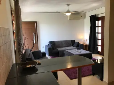 a living room with a couch and a table at Apokryfo, one bedroom apartment close to the beach in Pissouri