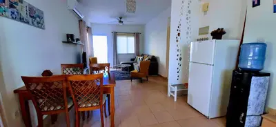 a kitchen and dining room with a white refrigerator at SUNNY HOME in Protaras
