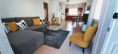 a living room with a couch and a table and chairs at SUNNY HOME in Protaras