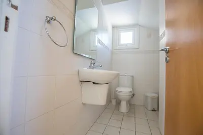 a bathroom with a toilet and a sink and a mirror at Protaras Villa Theodora 27 in Protaras