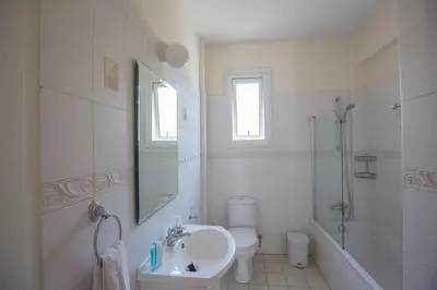 a bathroom with a sink and a toilet and a shower at Protaras Villa Theodora 27 in Protaras