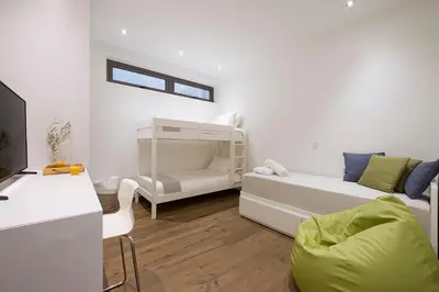 a small white room with a bed and a couch at Eros Cyprus in Ayia Napa