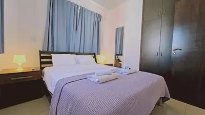 a bedroom with a bed with two towels on it at STAY Villa Anemone in Protaras