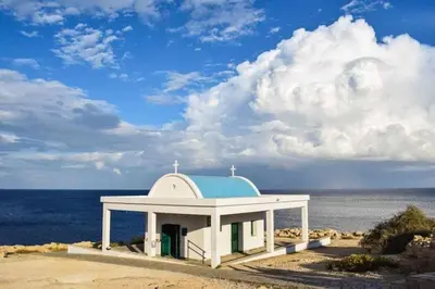 a chapel on the beach with the ocean in the background at My Holiday in Ayia Napa