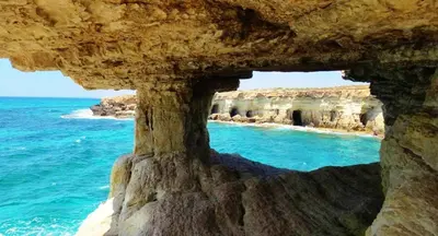 a view of the ocean through a rock cave at My Holiday in Ayia Napa