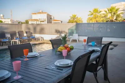 a table with a bowl of fruit on a patio at Villa Ruby Yiasemina in Ayia Napa