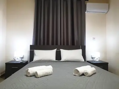 a bedroom with a bed with two towels on it at Leucolla Hill & Sea in Protaras