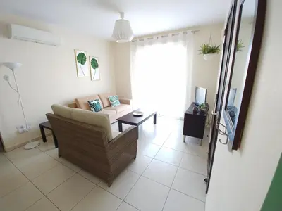 a living room with a couch and a table at AP10 Mythical Sands in Protaras