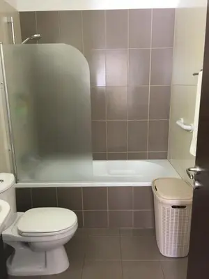a bathroom with a toilet and a bath tub at AP10 Mythical Sands in Protaras