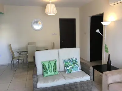 a living room with a couch and a table at AP10 Mythical Sands in Protaras