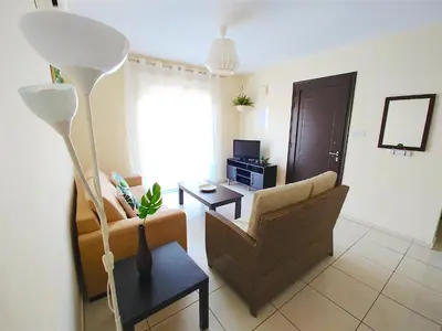 a living room with a couch and a table at AP10 Mythical Sands in Protaras