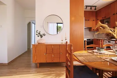 a kitchen and dining room with a table and a mirror at Phaedrus Living Luxury Flat Protaras Sea View 9 in Protaras