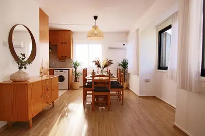 a kitchen and dining room with a table and a mirror at Phaedrus Living Luxury Flat Protaras Sea View 9 in Protaras