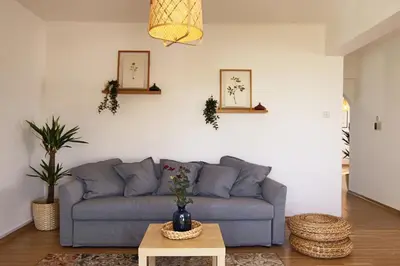 a living room with a blue couch and a table at Phaedrus Living Luxury Flat Protaras Sea View 9 in Protaras
