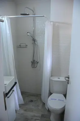a bathroom with a shower and a toilet and a sink at Lazaros Stonehouse in Pano Lefkara
