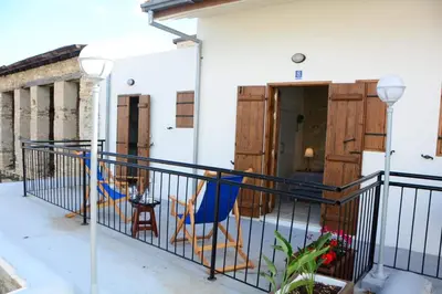 a balcony of a house with a blue chair at Lazaros Stonehouse in Pano Lefkara
