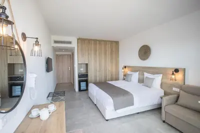 a hotel room with a bed and a couch at Bohemian Gardens Hotel in Protaras