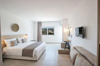 a hotel room with a bed and a couch at Bohemian Gardens Hotel in Protaras