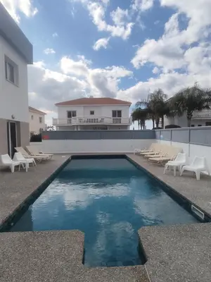 a swimming pool in front of a house at Villa Ruby Nissi Beach in Ayia Napa