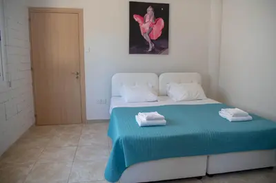 a bedroom with a bed with two towels on it at Villa Ruby Nissi Beach in Ayia Napa