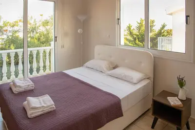 a bedroom with a bed with towels on it at Villa Ruby Nissi Beach in Ayia Napa