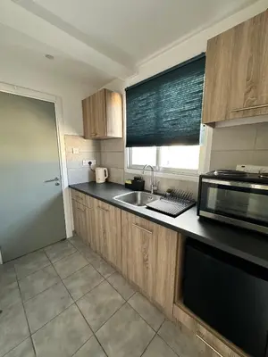 a kitchen with a sink and a microwave at Top floor apartment in Nicosia with view! in Nicosia