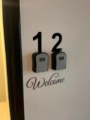 a welcome sign with two clocks on a wall at Top floor apartment in Nicosia with view! in Nicosia