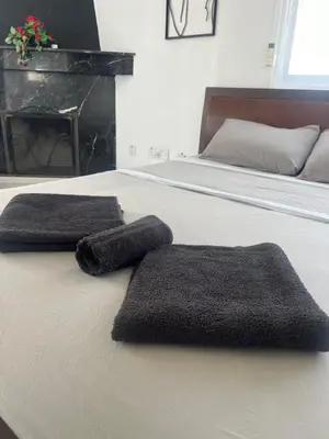 two towels sitting on top of a bed at Top floor apartment in Nicosia with view! in Nicosia