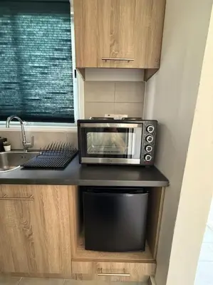 a microwave sitting on a counter in a kitchen at Top floor apartment in Nicosia with view! in Nicosia