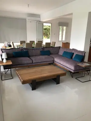 a living room with a large couch and tables at Oasi Rejuve Poseidon in Meneou