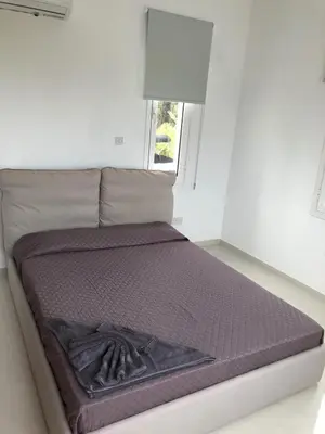 a large bed in a room with a window at Oasi Rejuve Poseidon in Meneou