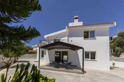 a large white house with a porch in front of it at Villa Alleli in Protaras