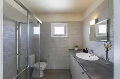 a bathroom with a toilet and a sink and a shower at Villa Alleli in Protaras