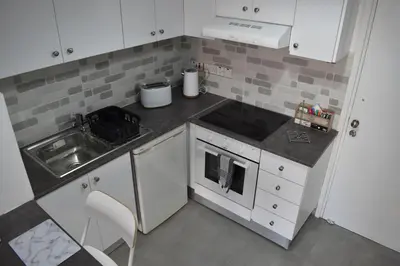 a small kitchen with a sink and a stove at Marias Apartment - in city centre,near beach in Larnaka