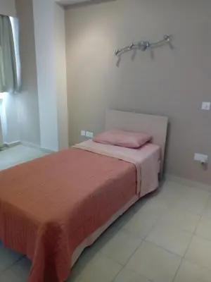 a bedroom with a bed with a pink blanket on it at 3 Bedroom Apartment in Nicosia