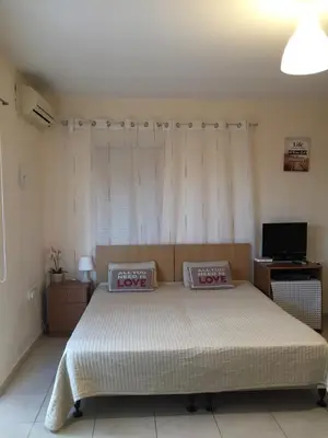 a bedroom with a bed with two pillows on it at Holidays in Cyprus in Ayia Napa