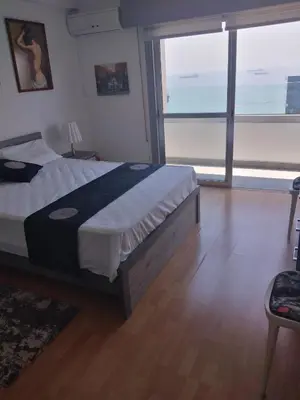a bedroom with a bed and a large window at Amazing Sea Place in Limassol
