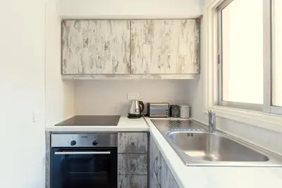 a kitchen with a sink and a counter top at Furnished Seafront Studio in Larnaka